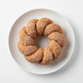 Twisted donut coated in cinnamon and sugar